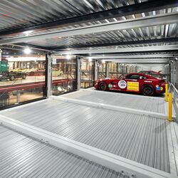 Interior view of the parking system with a sports car parked inside