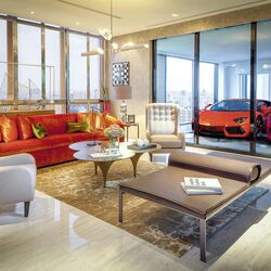 The living room of a flat, with the cars parked in the sky garage